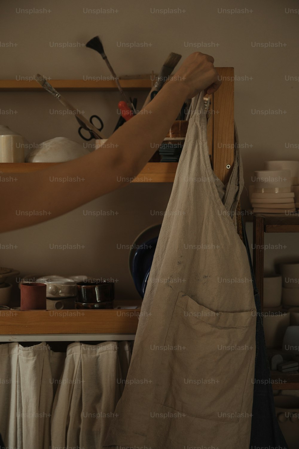 a person holding a bag in front of a shelf