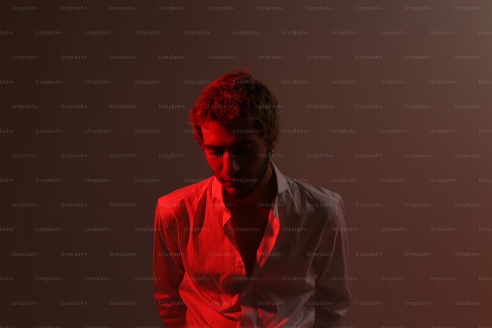 a man in a white shirt and a red light