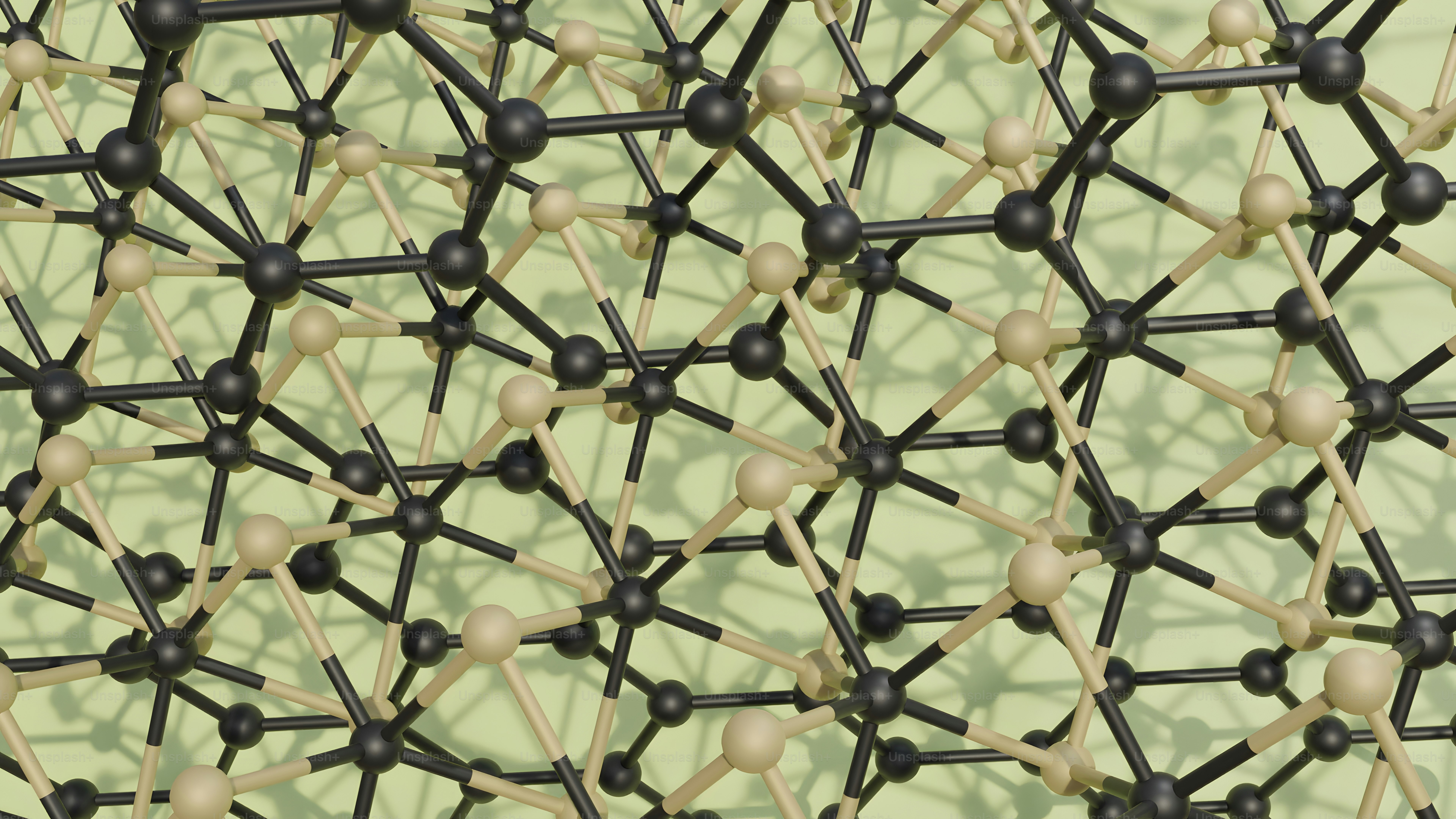 a bunch of black and white balls on a green surface