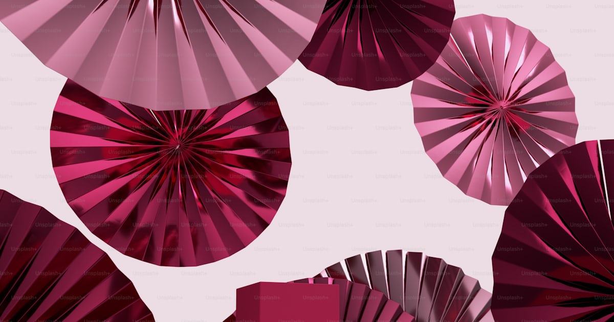 A group of pink fans sitting next to each other photo – Magenta ...