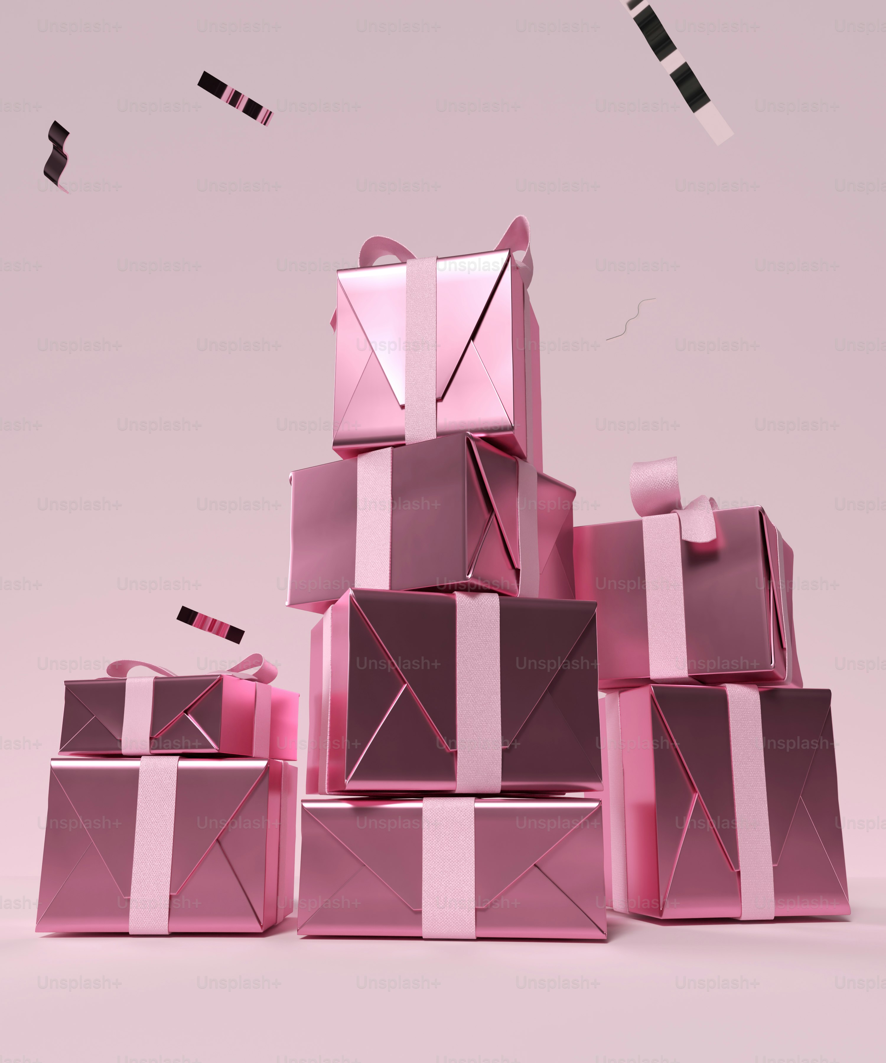 a pile of pink boxes with ribbons on them