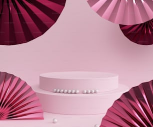 a white cake with pink paper fans behind it