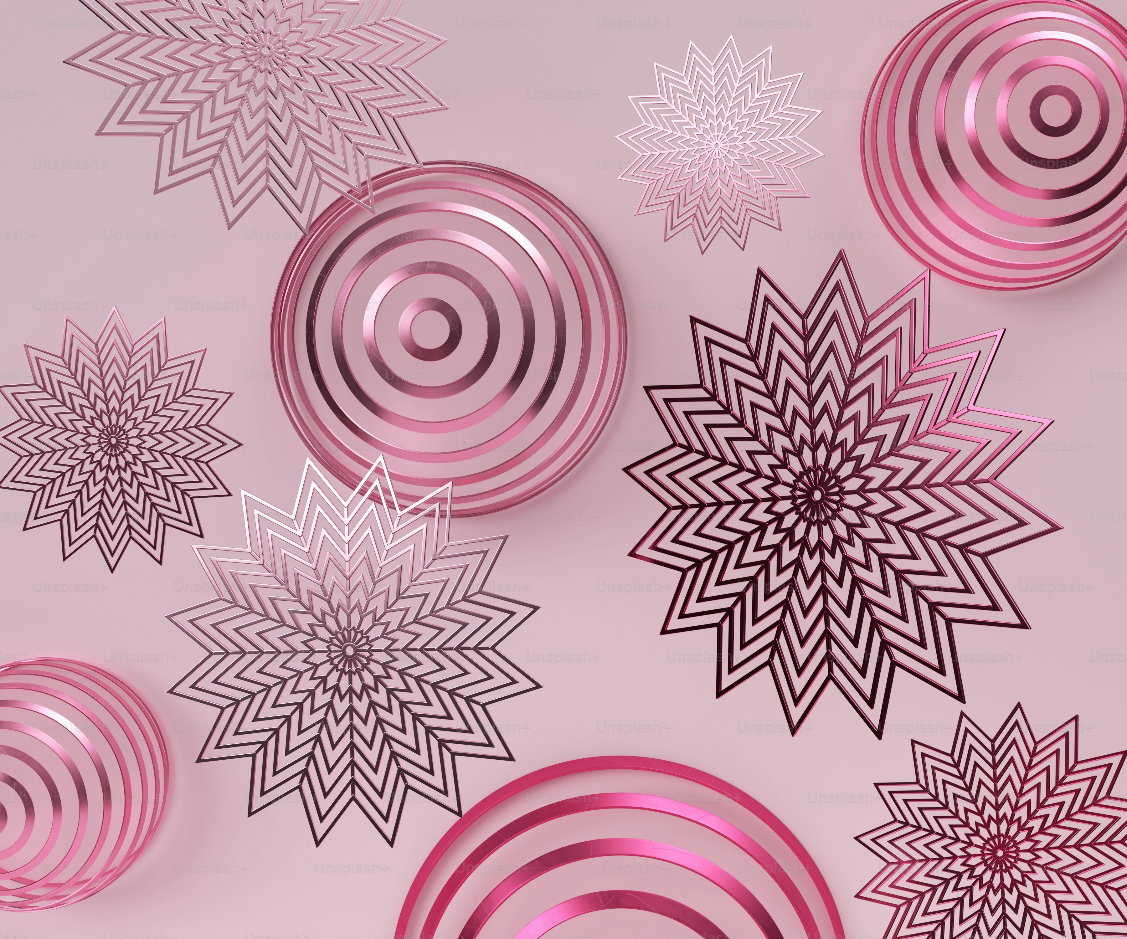 a group of pink and black ornaments on a pink background