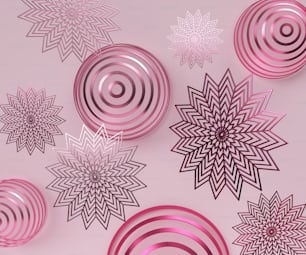 a group of pink and black ornaments on a pink background