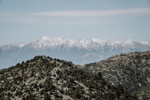 a mountain range with snow capped mountains in the background