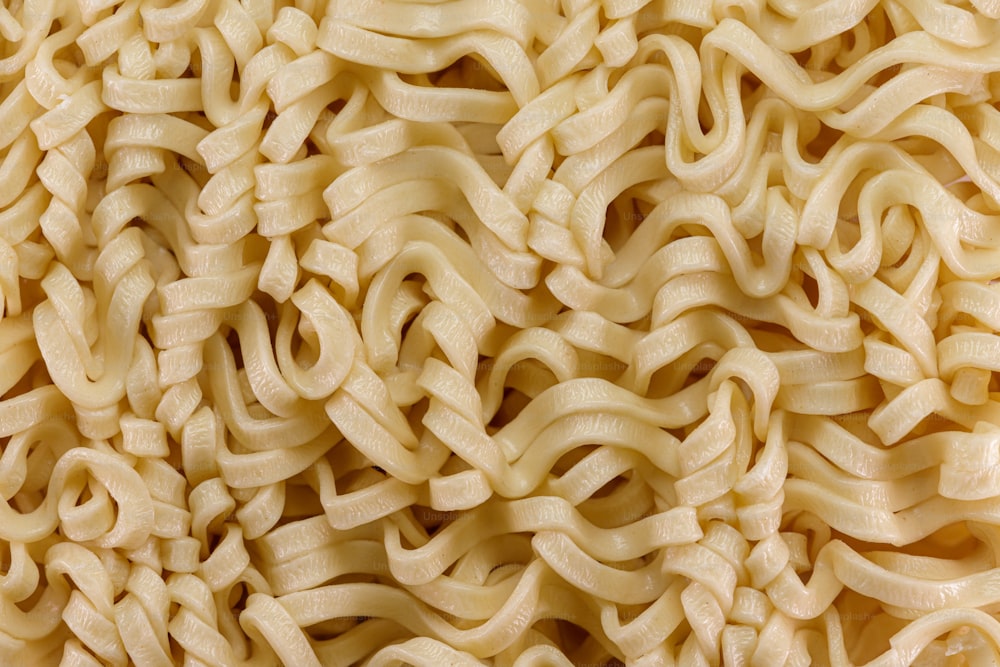 a close up of a pile of uncooked noodles