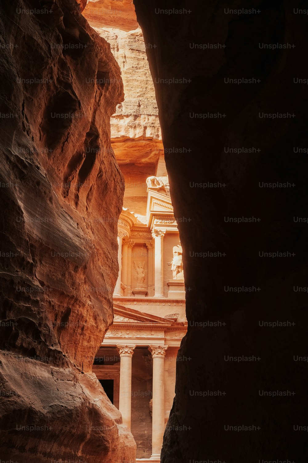 a narrow passage between two buildings in a canyon