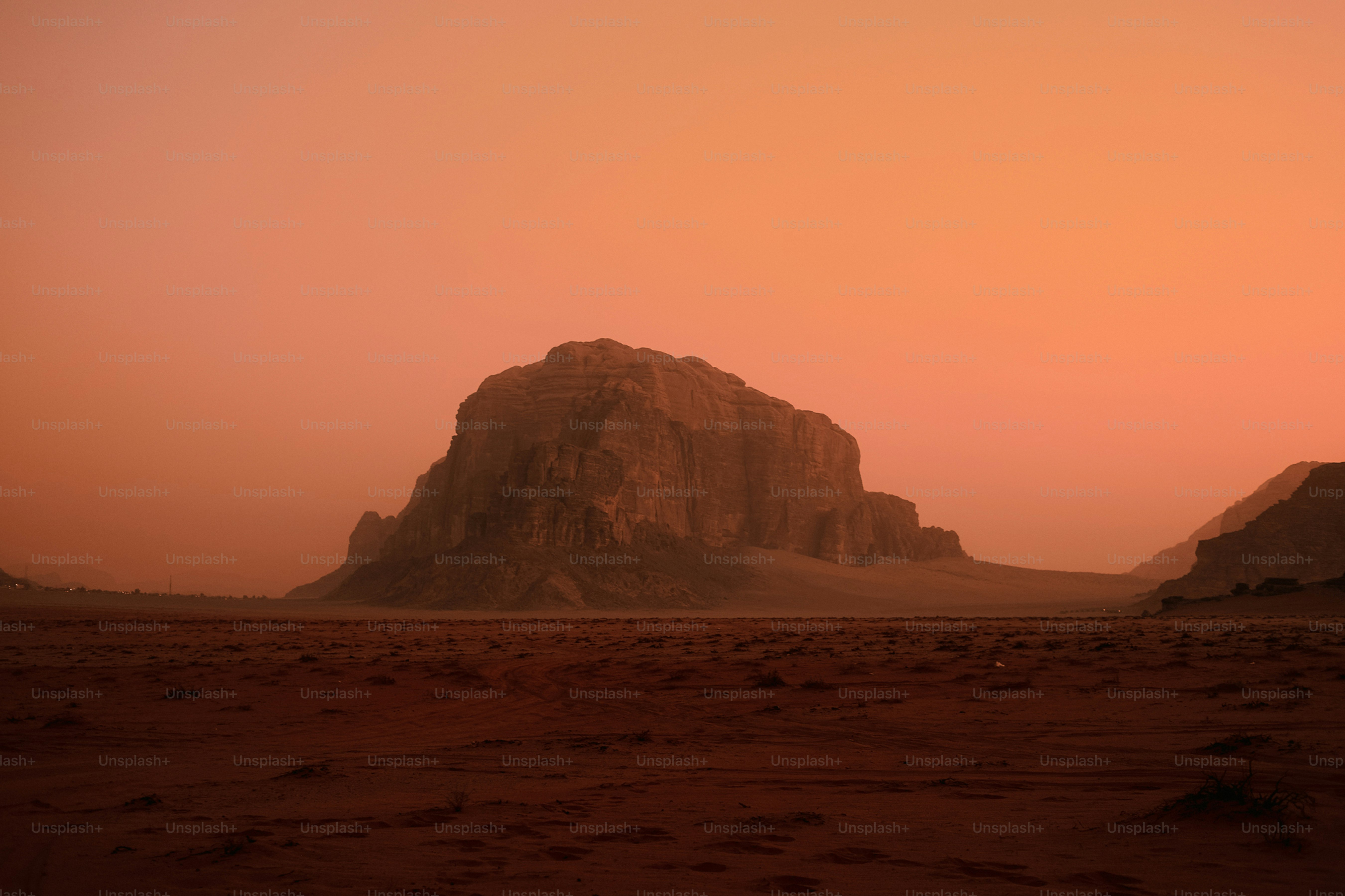 a large rock formation in the middle of a desert