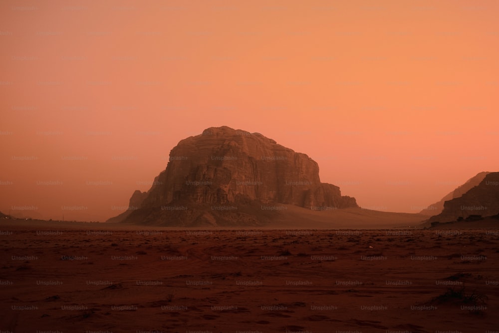 a large rock formation in the middle of a desert