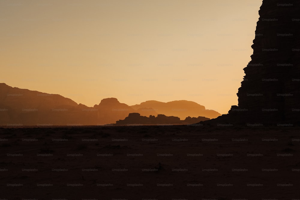 a silhueta de uma formação rochosa no deserto