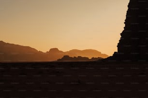 the silhouette of a rock formation in the desert