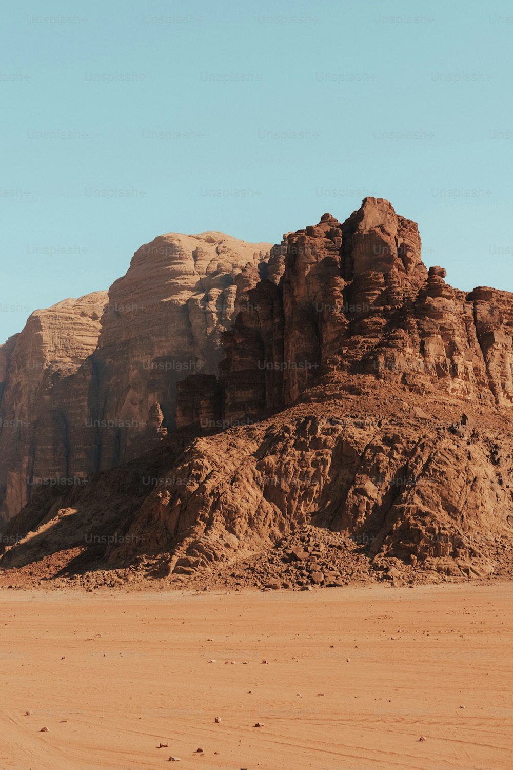 a large rocky mountain with a sky background