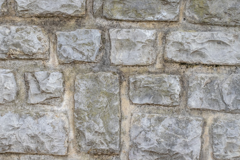 a close up of a wall made of stone blocks