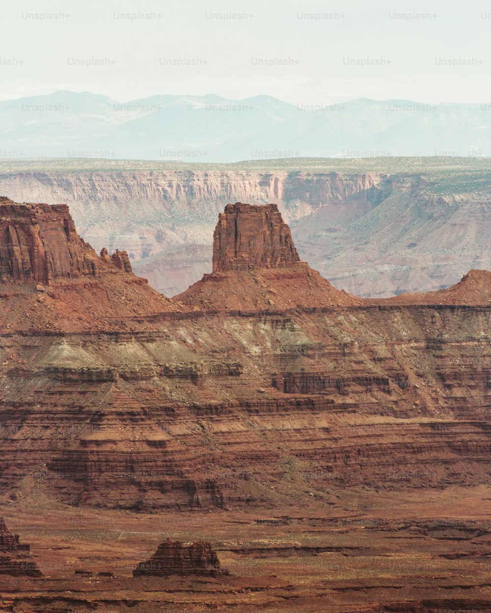 a view of a canyon with mountains in the background