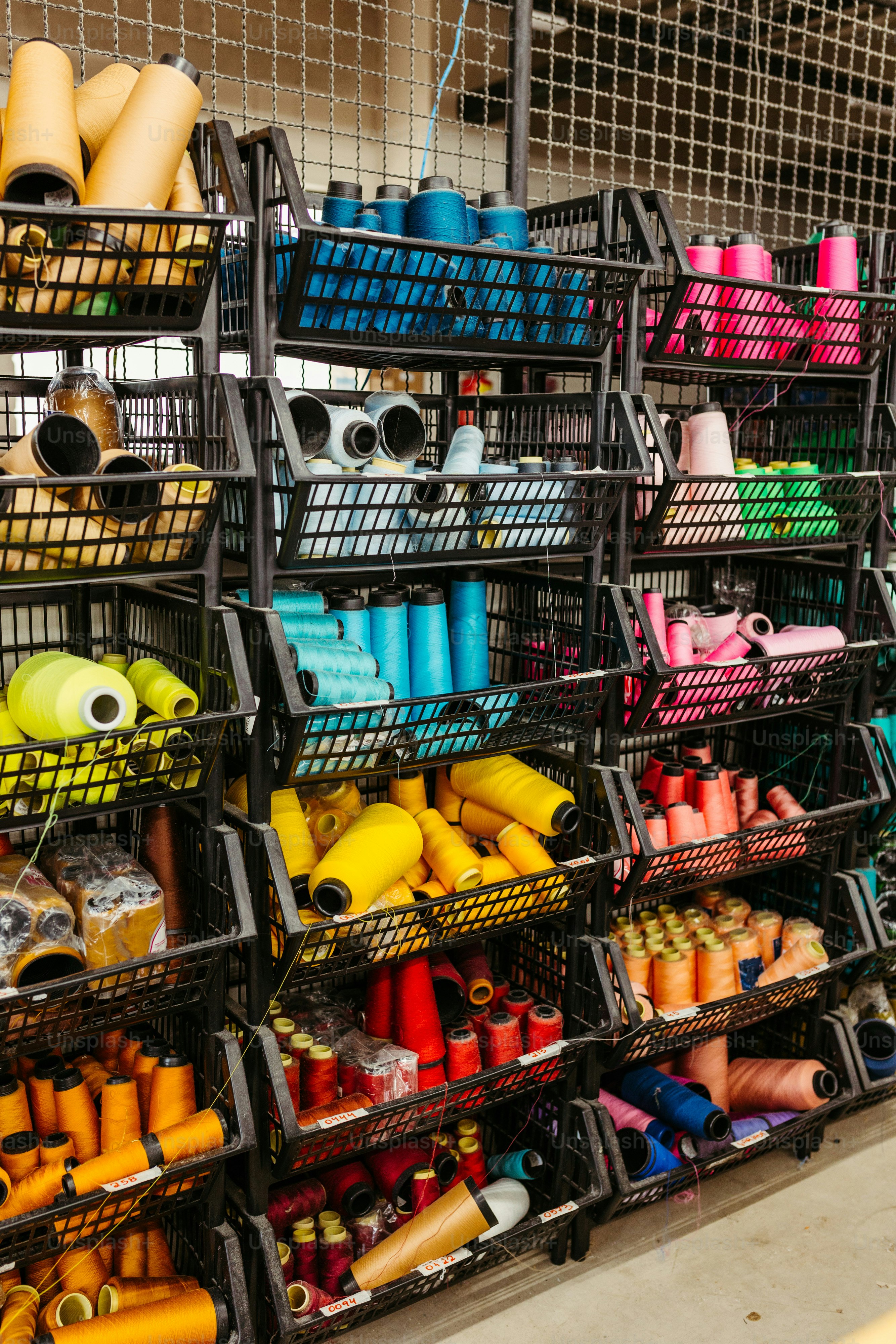 A display of different colored spools of thread photo – Fashion Image ...