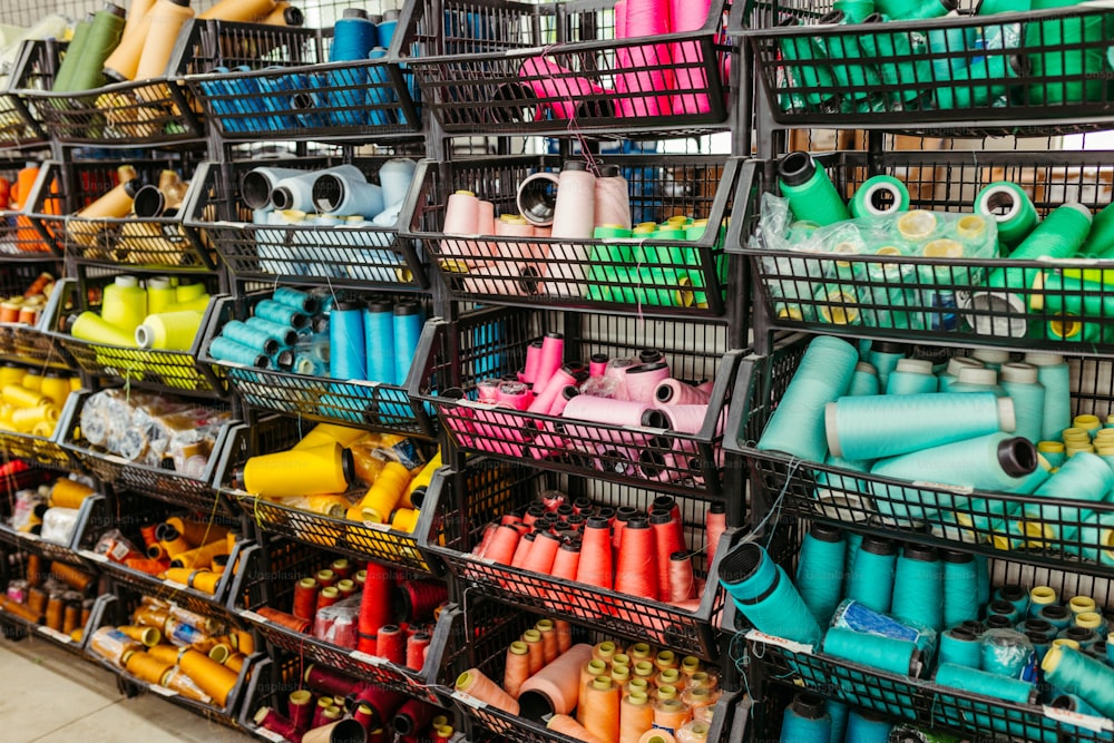 a display of various colored spools of thread