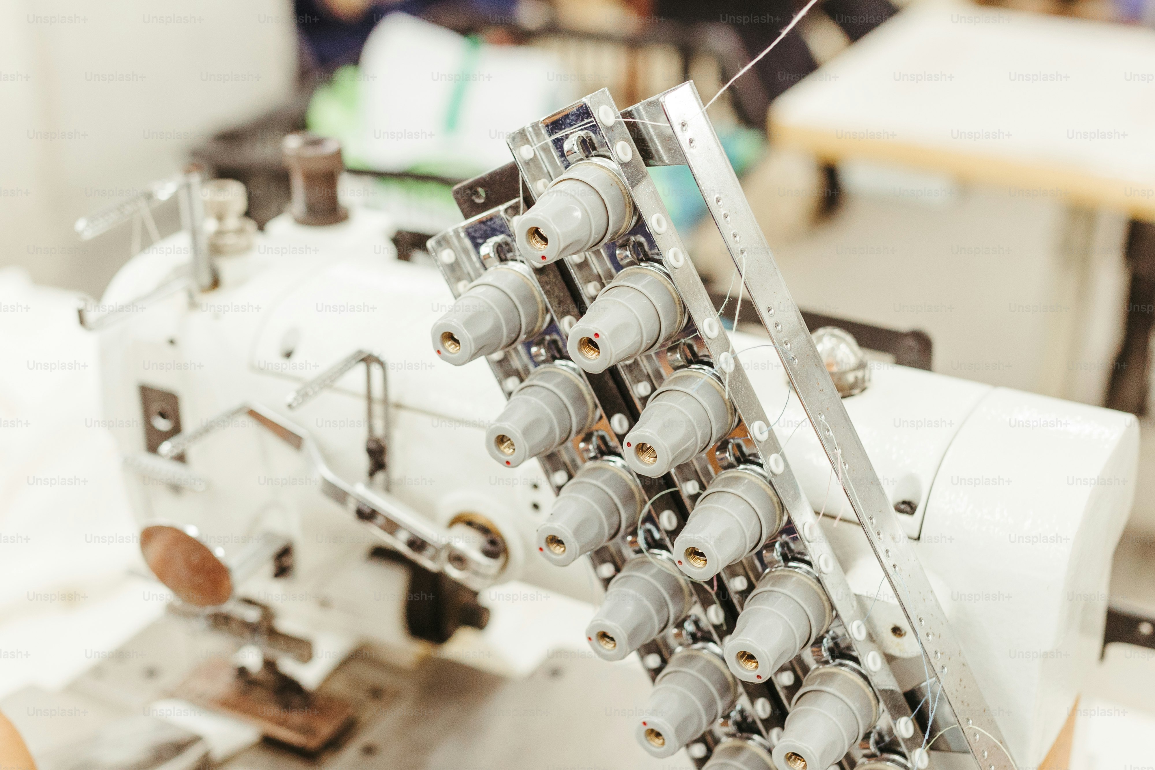 A close up of a sewing machine on a table photo – Fashion industry ...