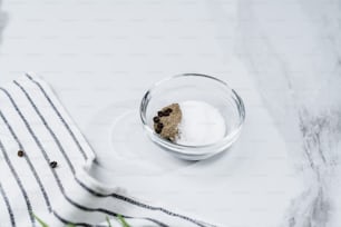 a glass bowl filled with sugar and a spoon