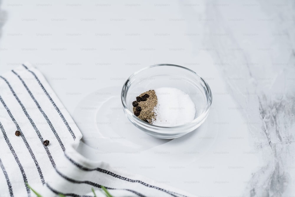 a glass bowl filled with sugar and a spoon