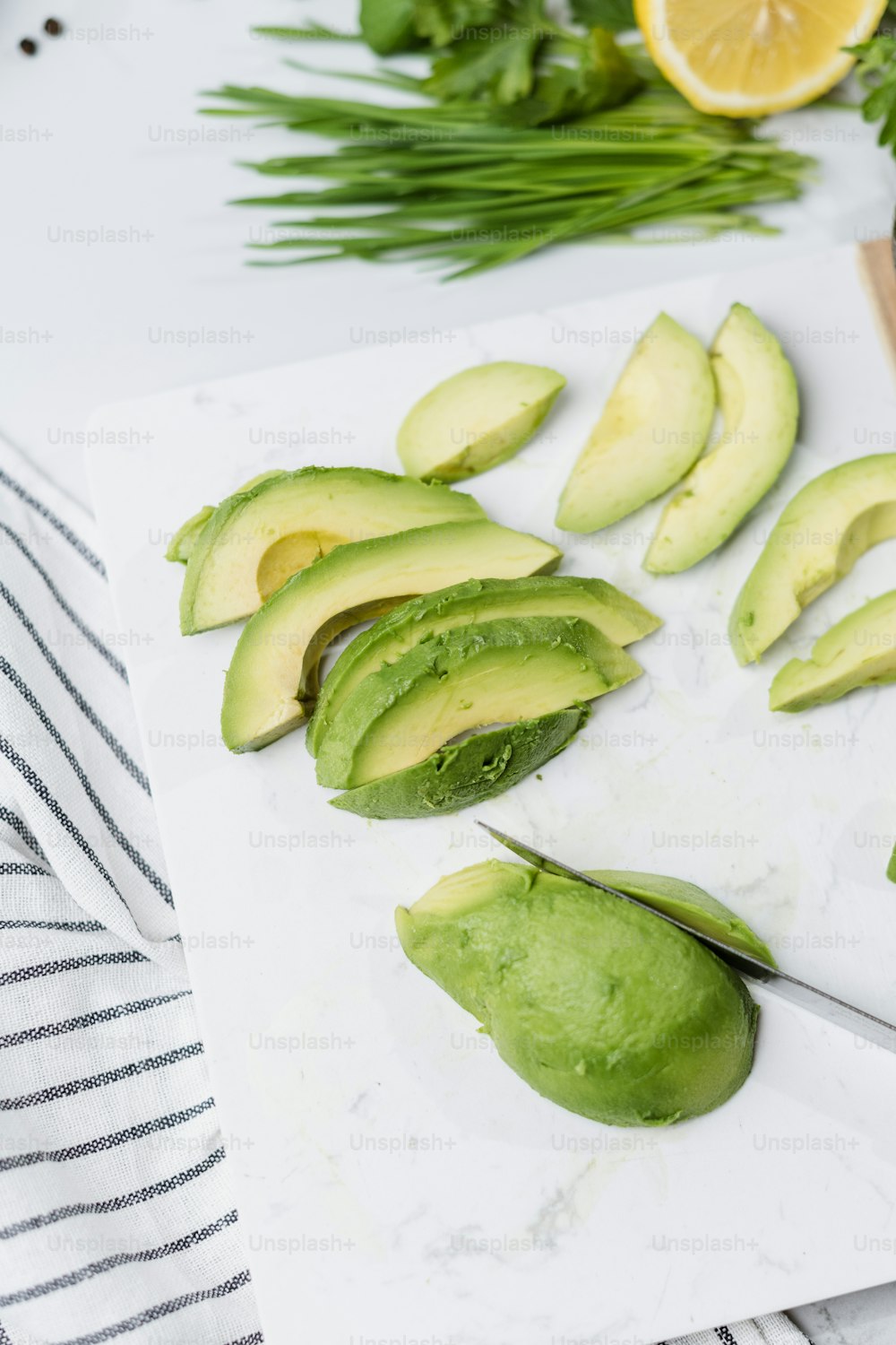 avocados cut up on a cutting board with a knife