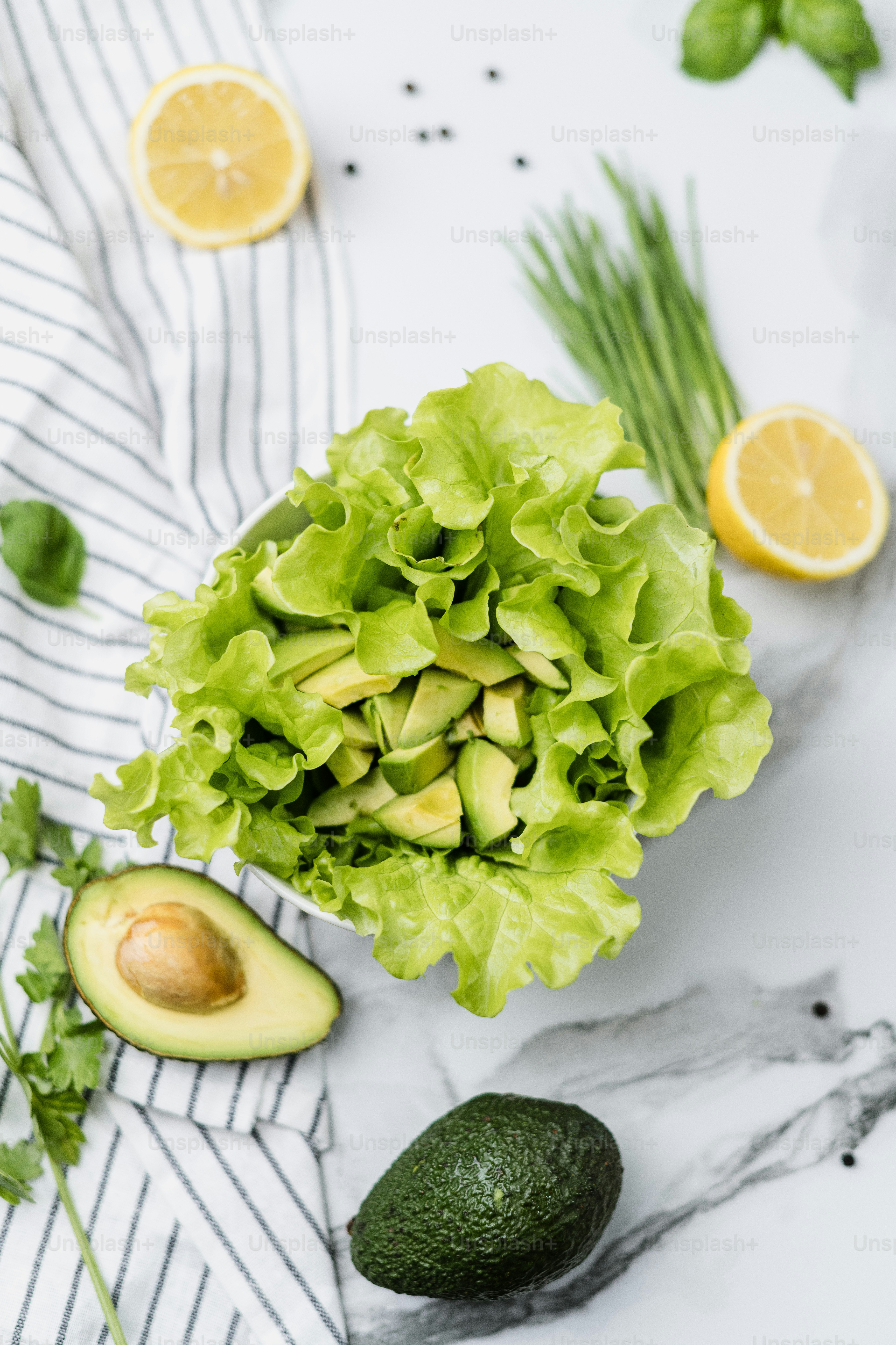 lettuce, avocado, and lemons on a table