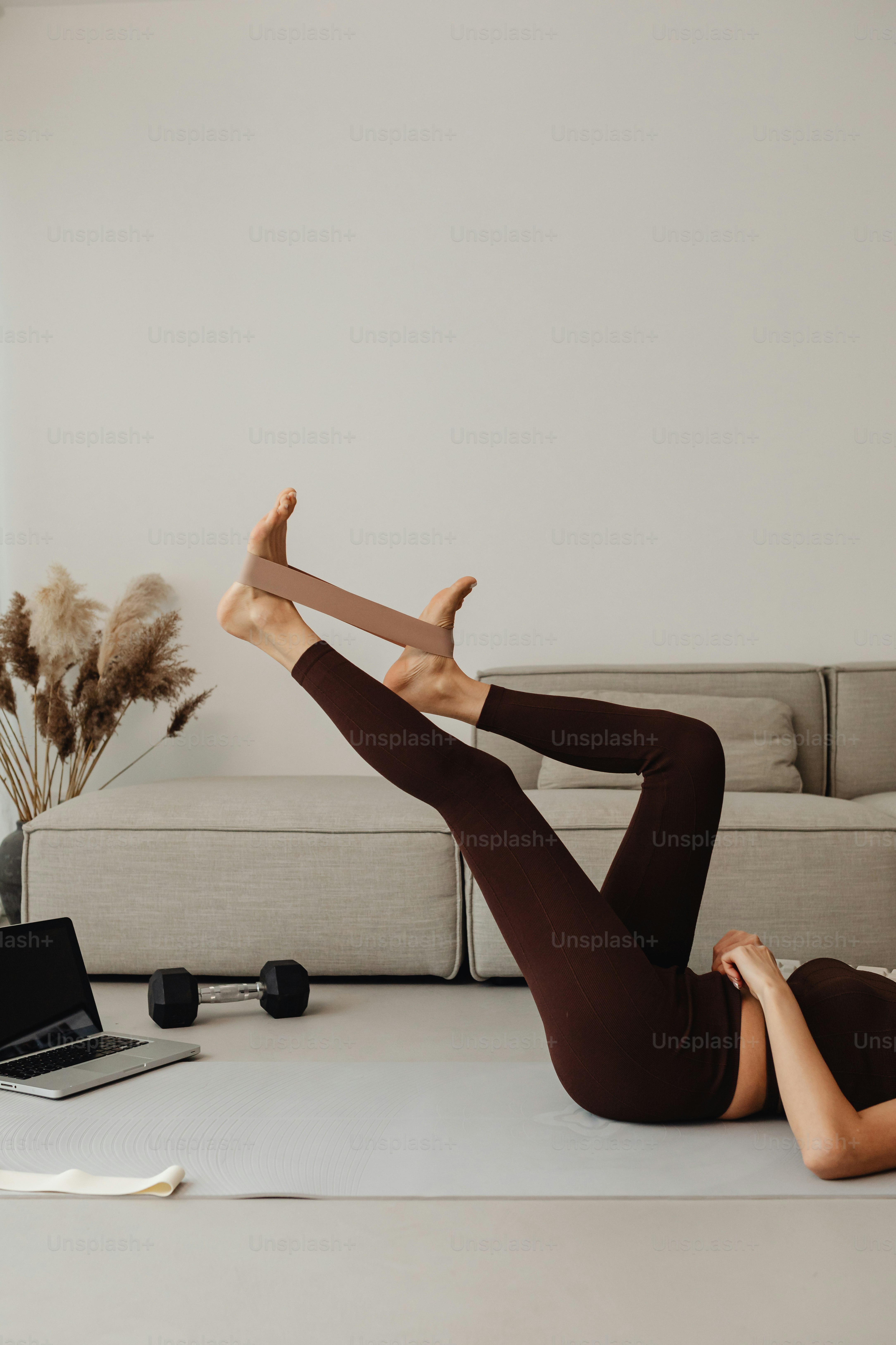 a woman laying on the floor with a laptop