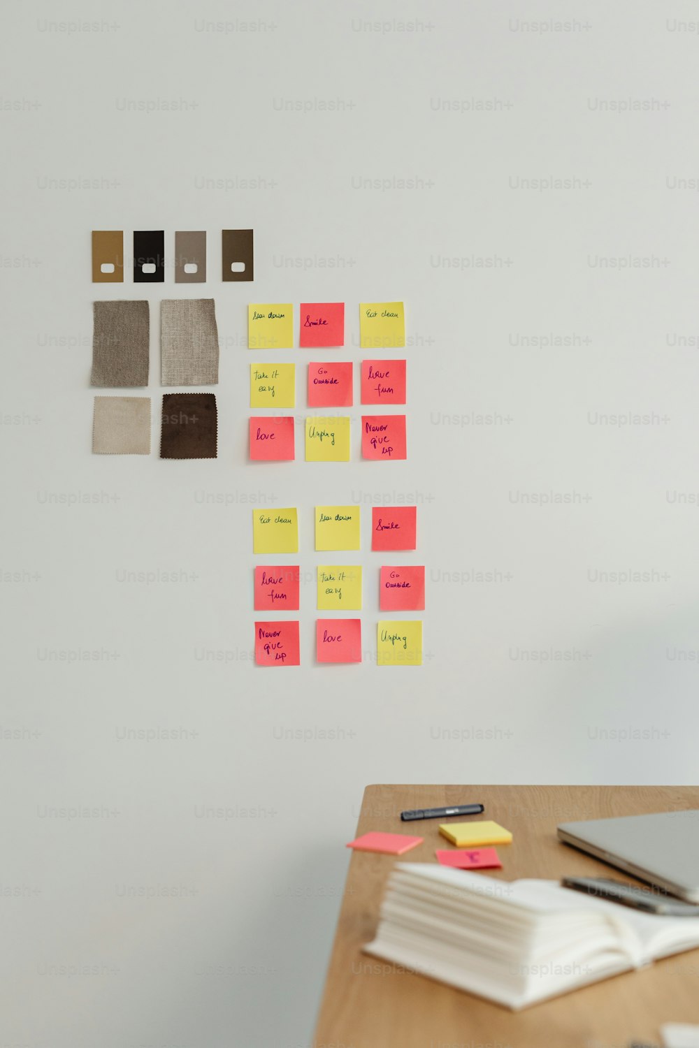 a desk with sticky notes attached to the wall