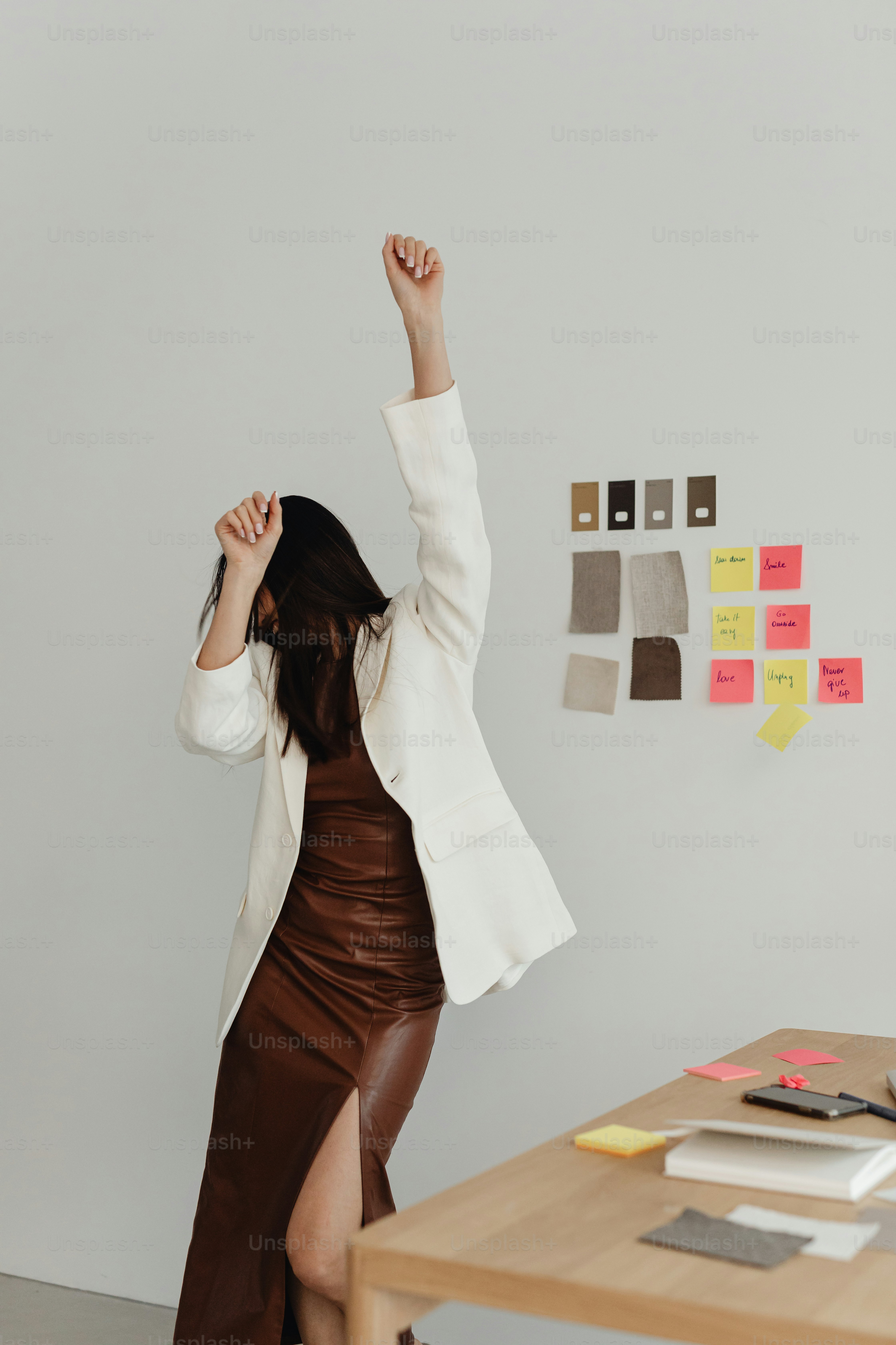 a woman in a brown skirt and a white jacket