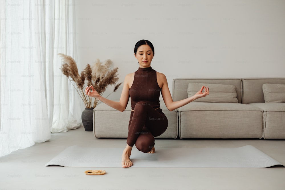 Eine Frau macht Yoga in einem Wohnzimmer
