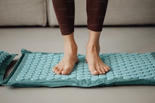 a person standing on a mat on the floor