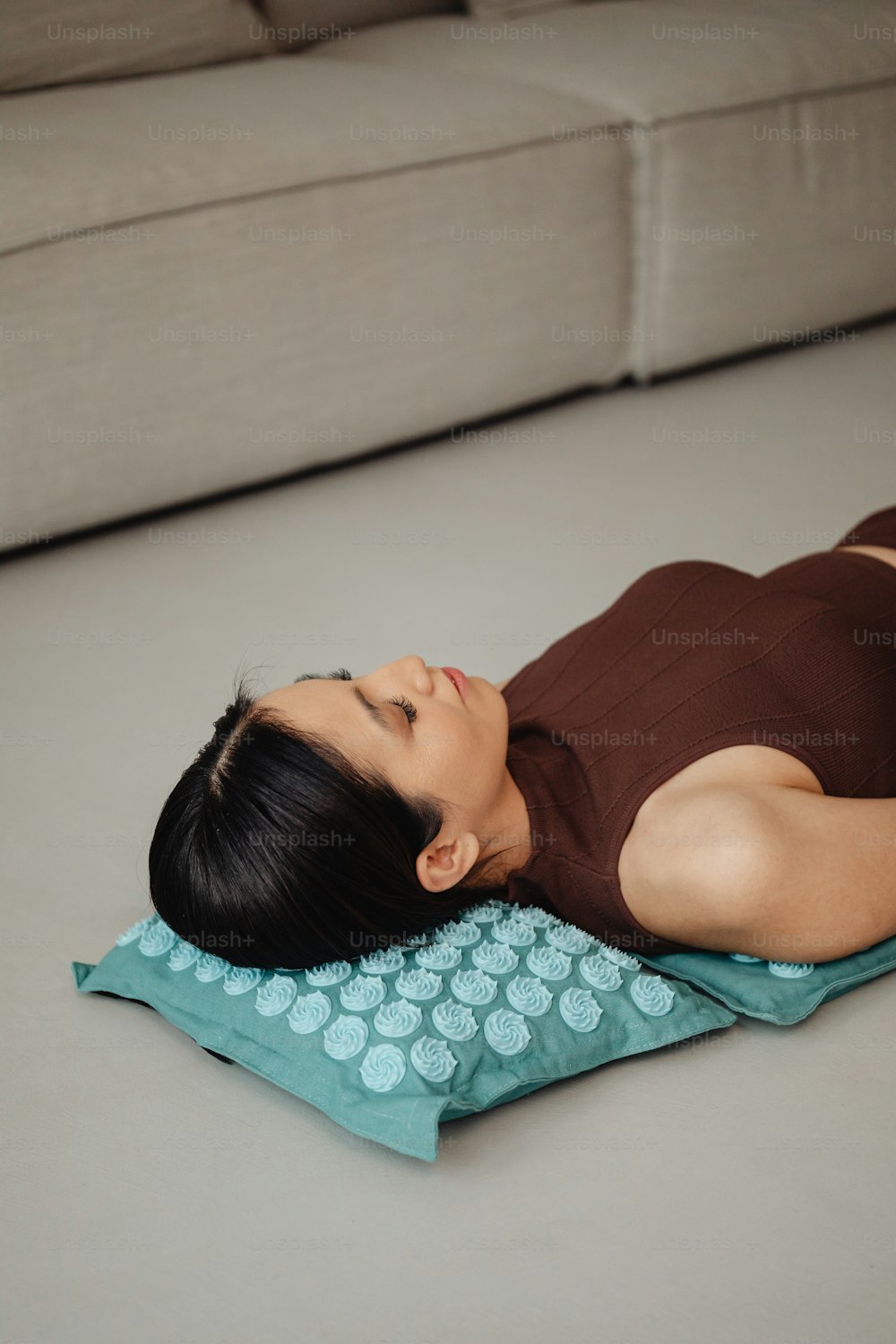 Una mujer acostada sobre una almohada en el suelo