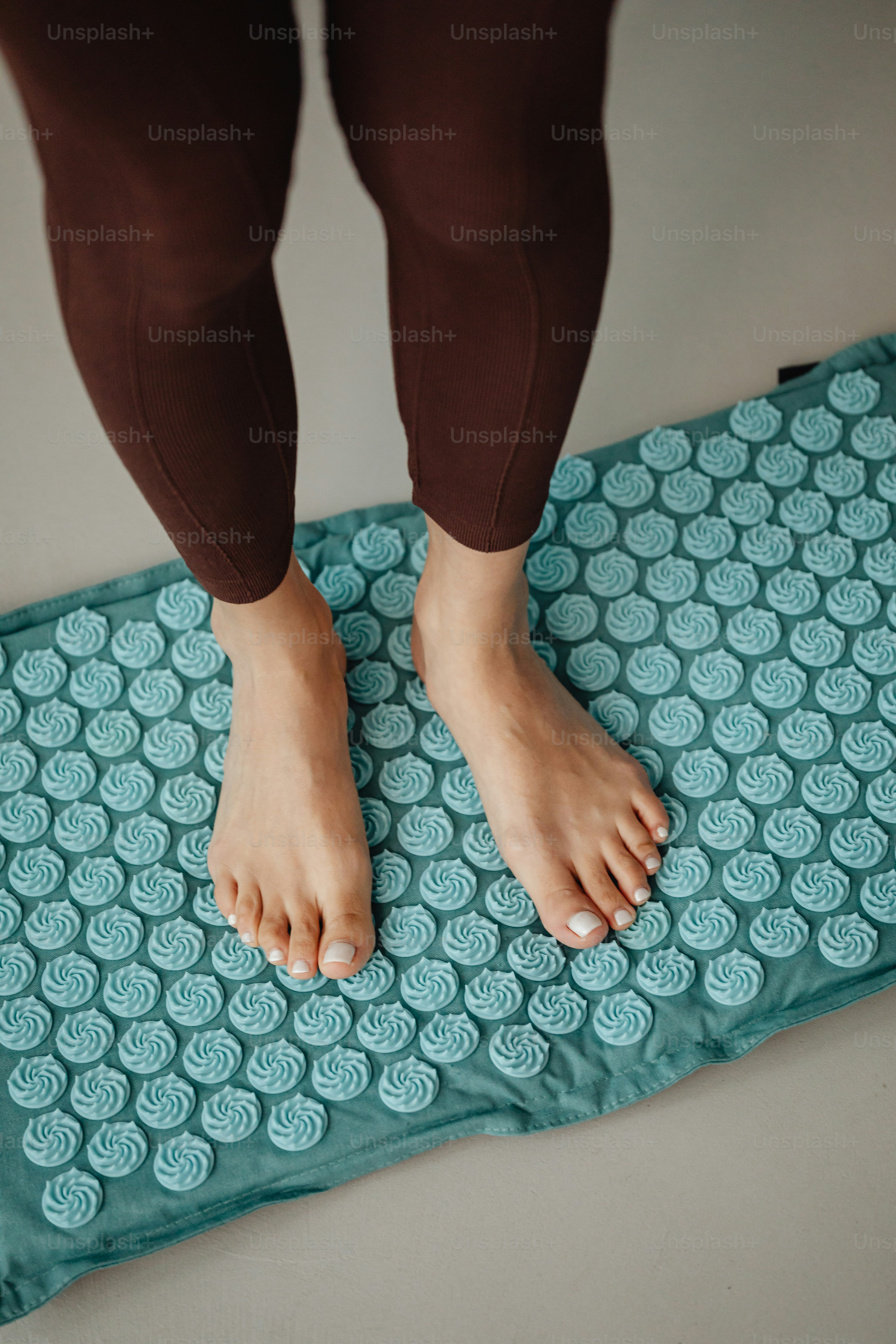a person standing on a mat on the floor