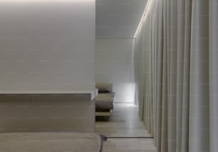 a bedroom with a bed and a white curtain