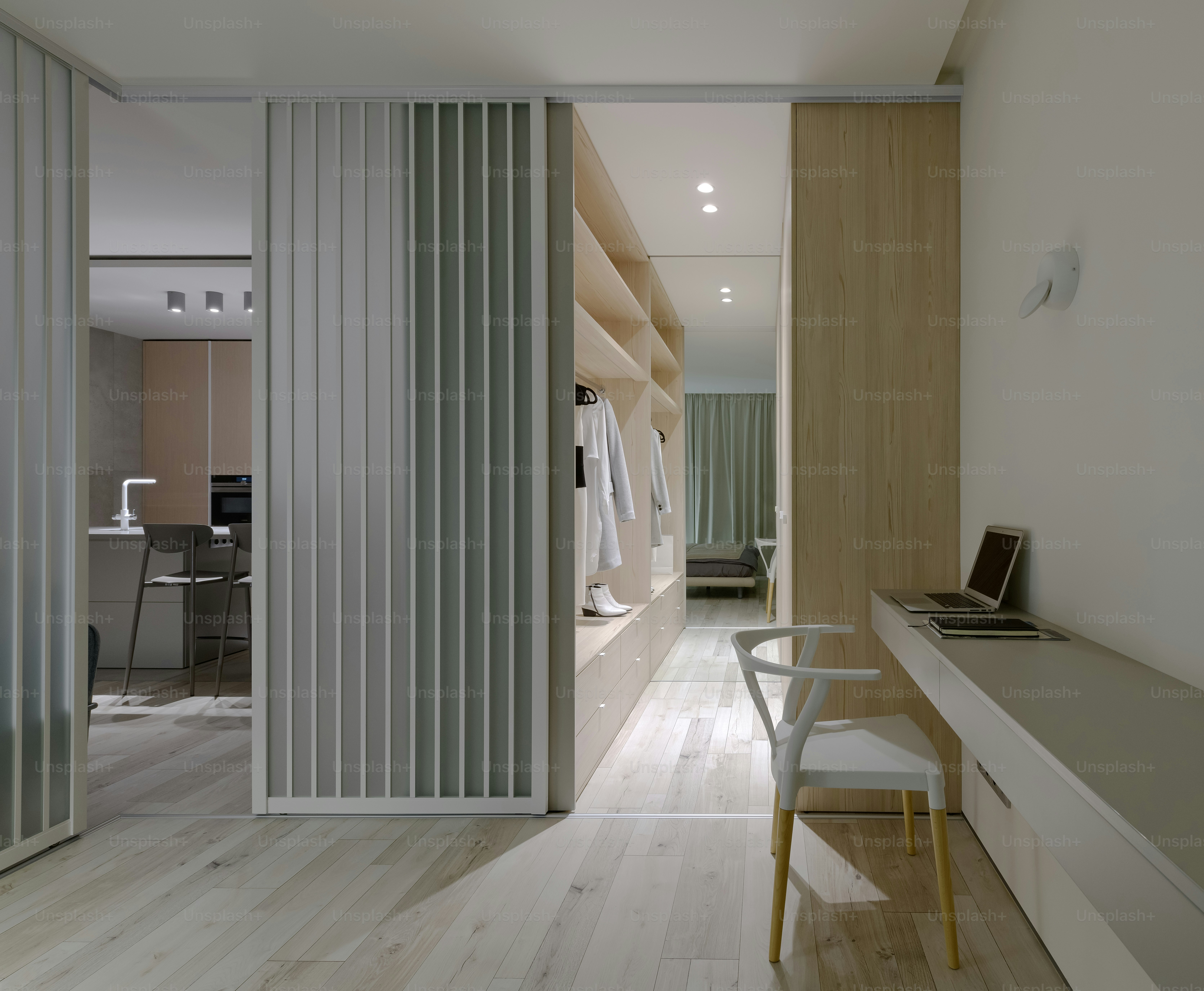 a room with a chair, desk, and closet