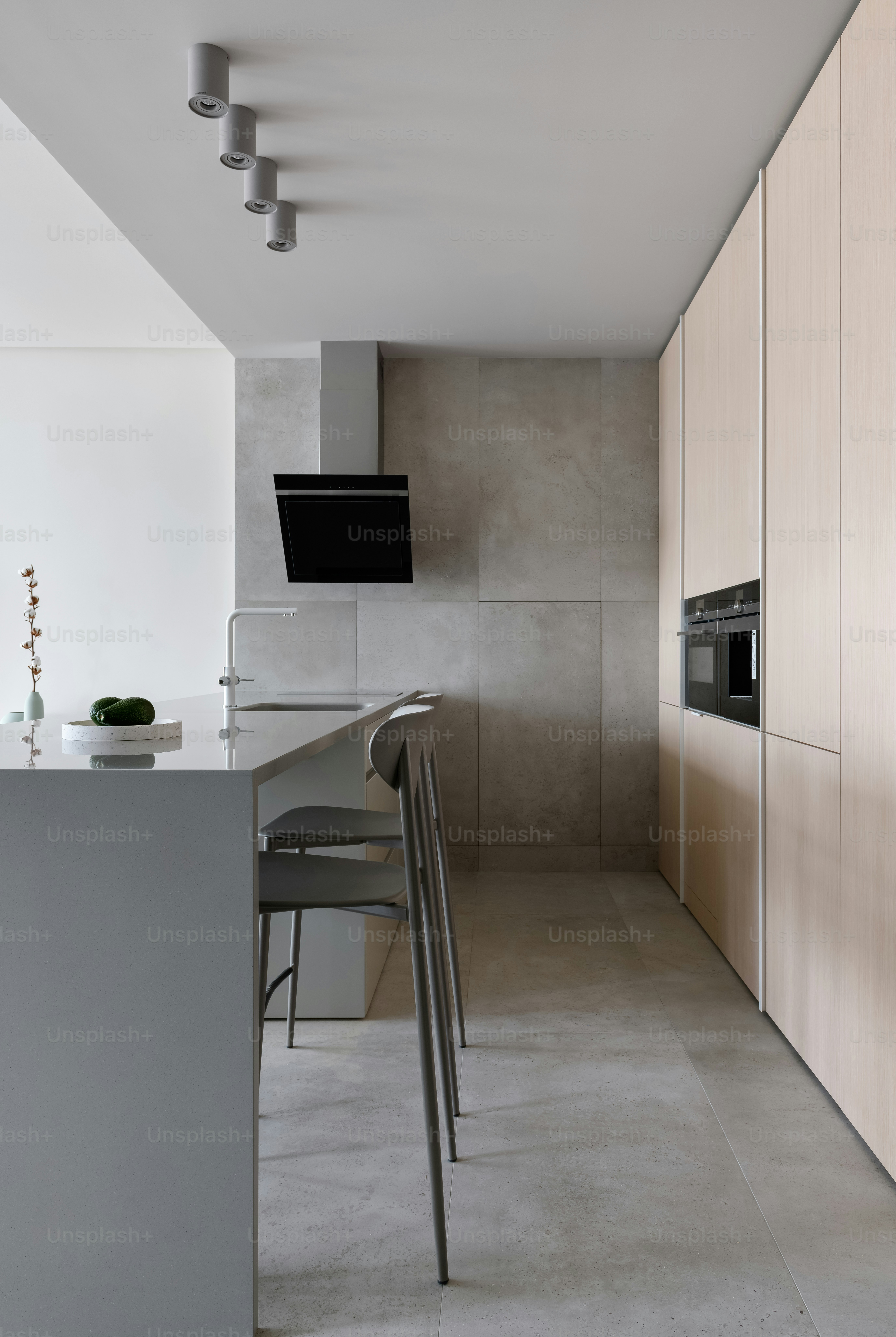 a kitchen with a counter top and chairs