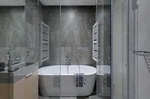 a bathroom with a tub, sink, and mirror