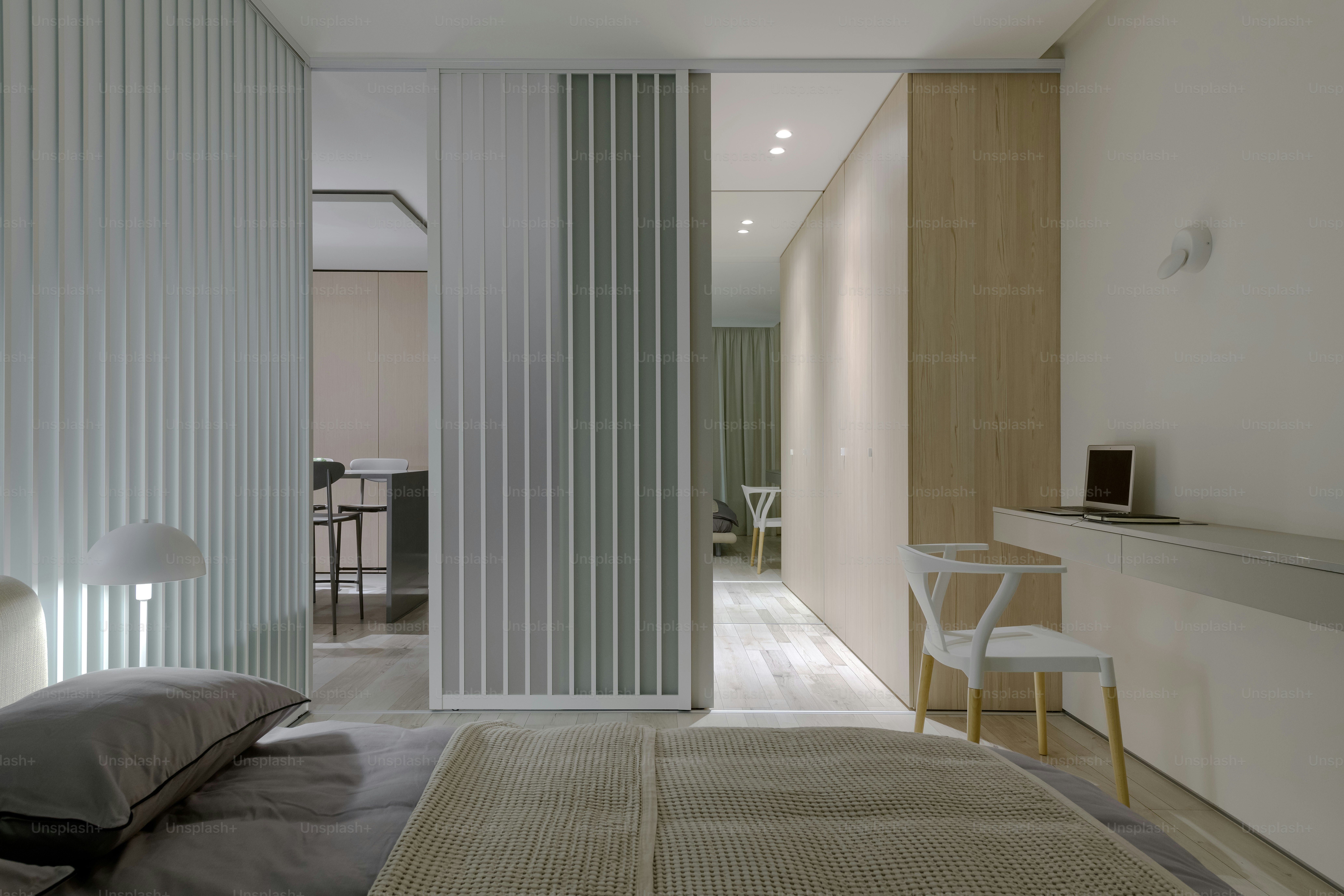a bedroom with a large bed and a sliding glass door
