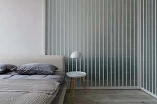 a bed sitting next to a wall with vertical blinds
