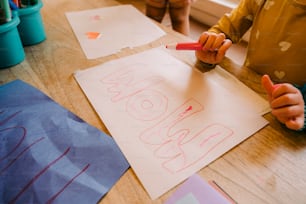 a child is drawing on a piece of paper