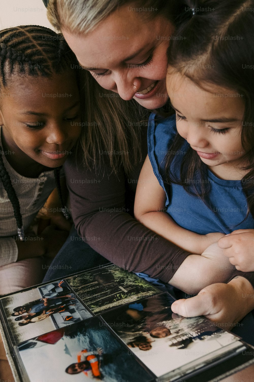 a woman and two children looking at a picture