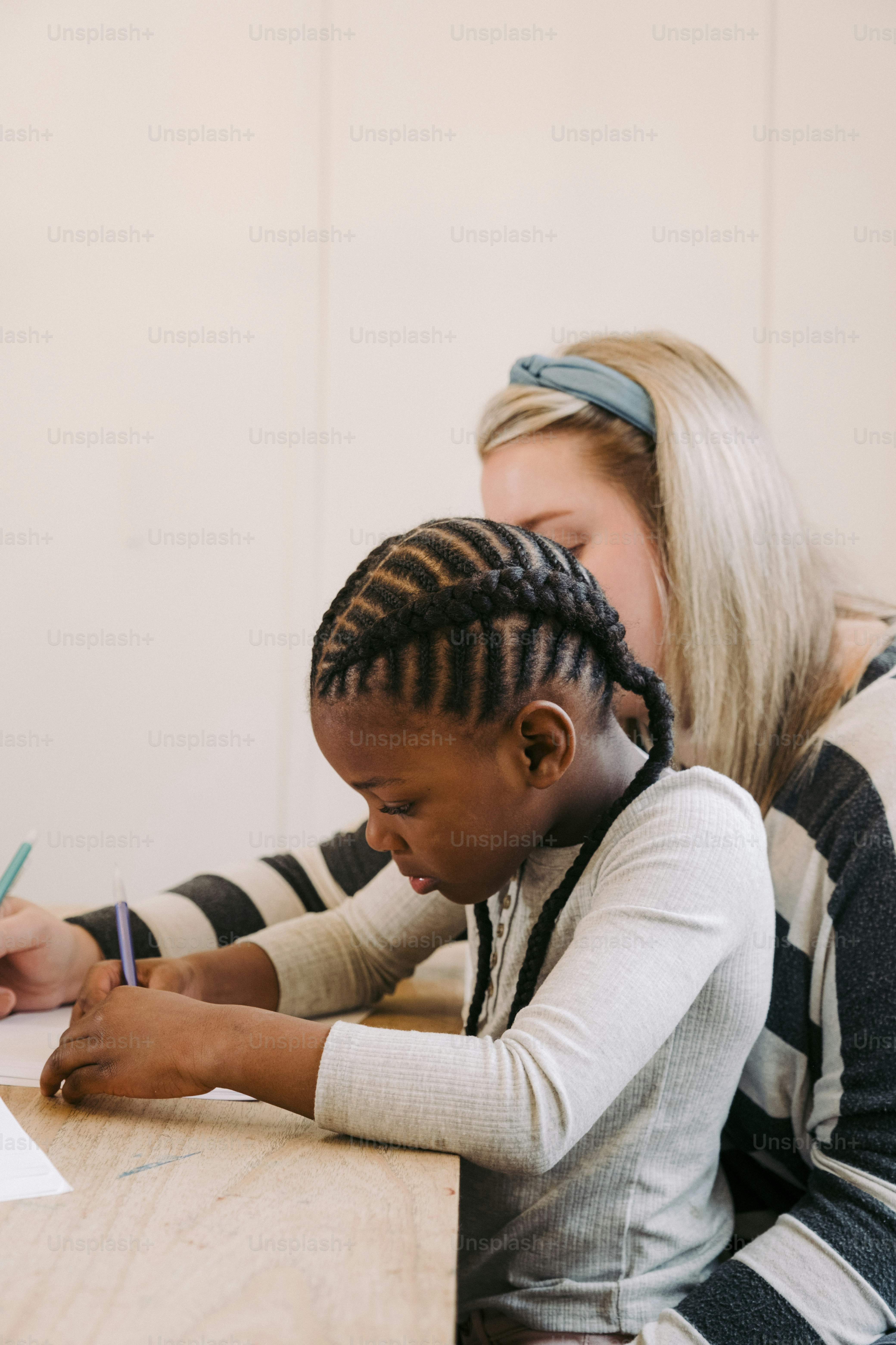 a woman sitting at a table with a child