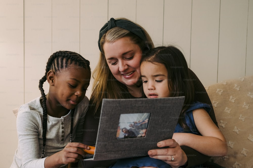 Una mujer y dos niños mirando una foto en una tableta