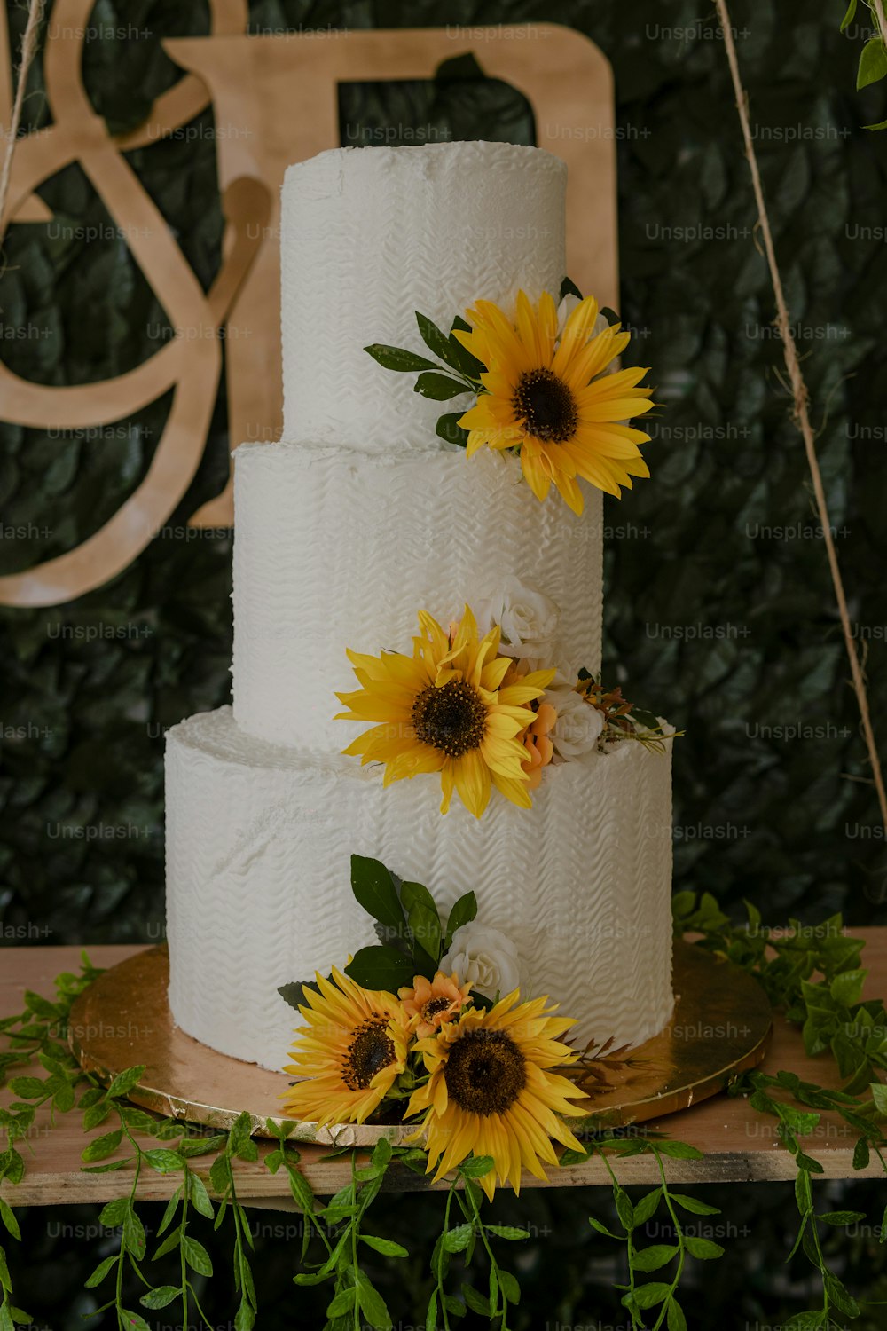 a wedding cake with sunflowers on top of it