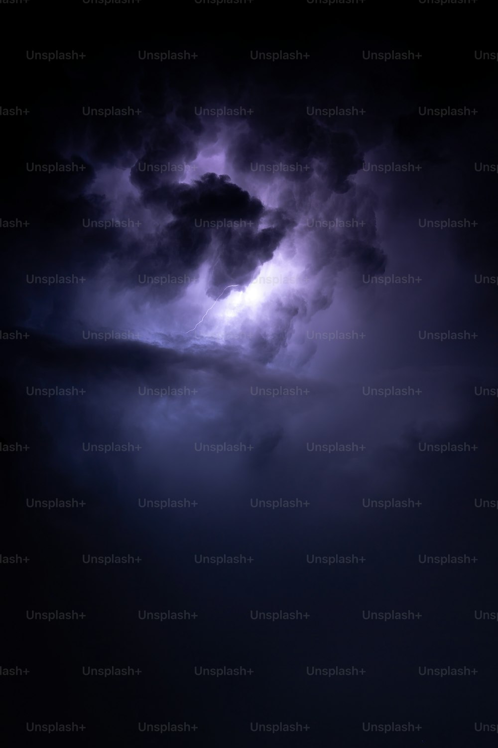 a large cloud with a lightning bolt in the middle of it