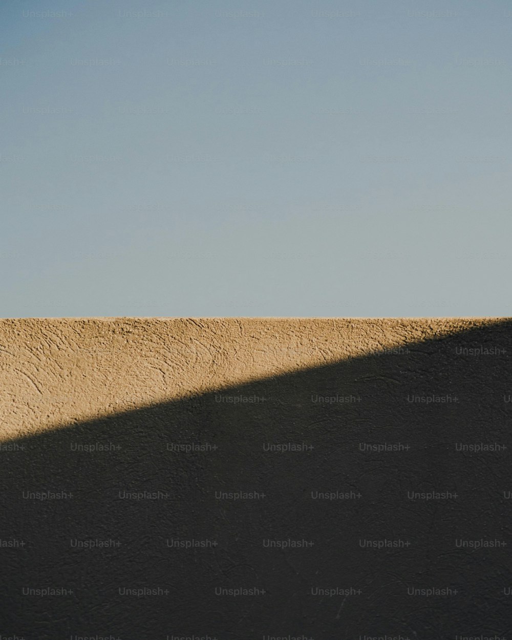 a man riding a skateboard on top of a cement wall