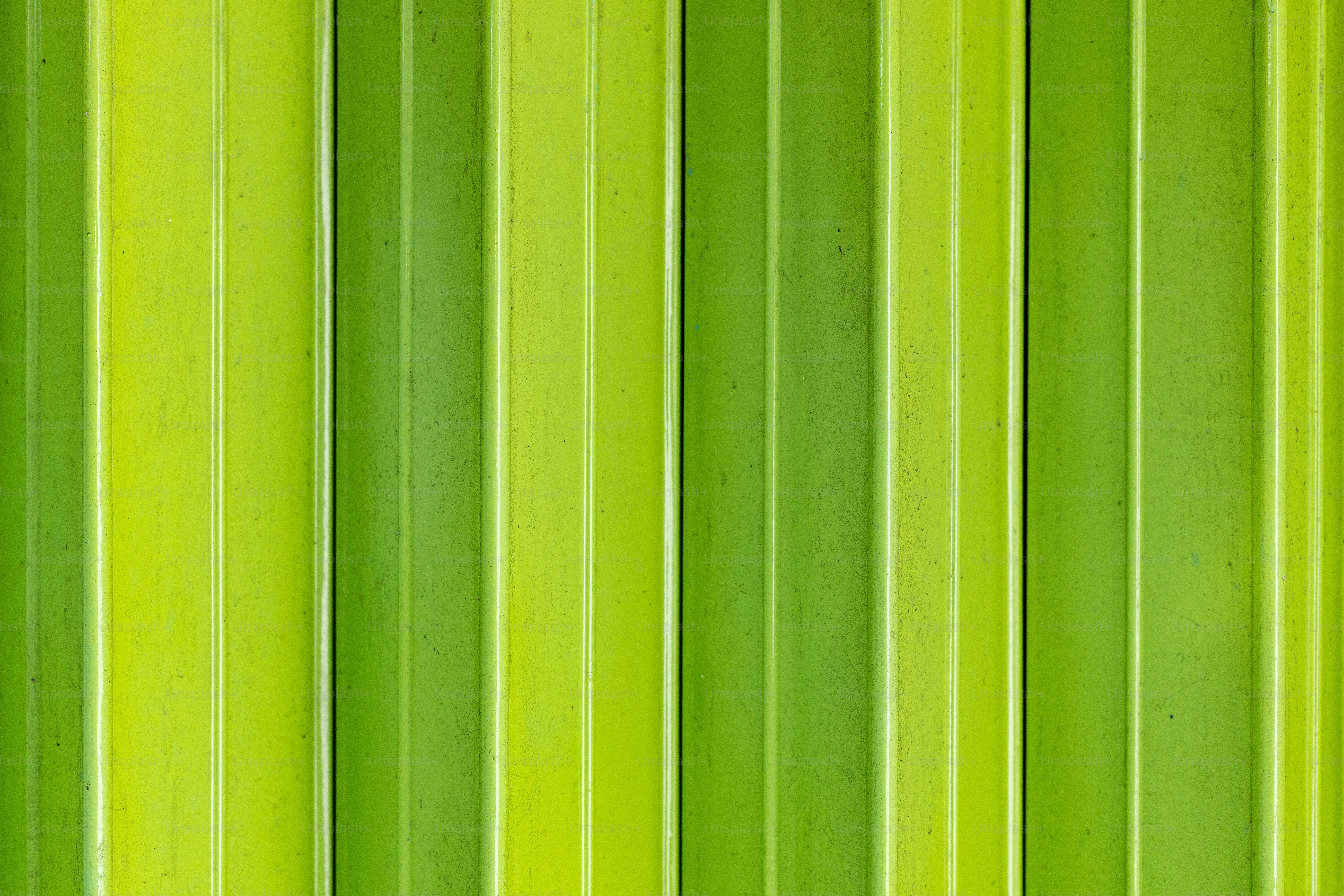 a close up of a green wall with vertical lines