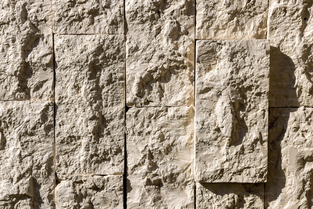 a close up of a wall made of stone blocks