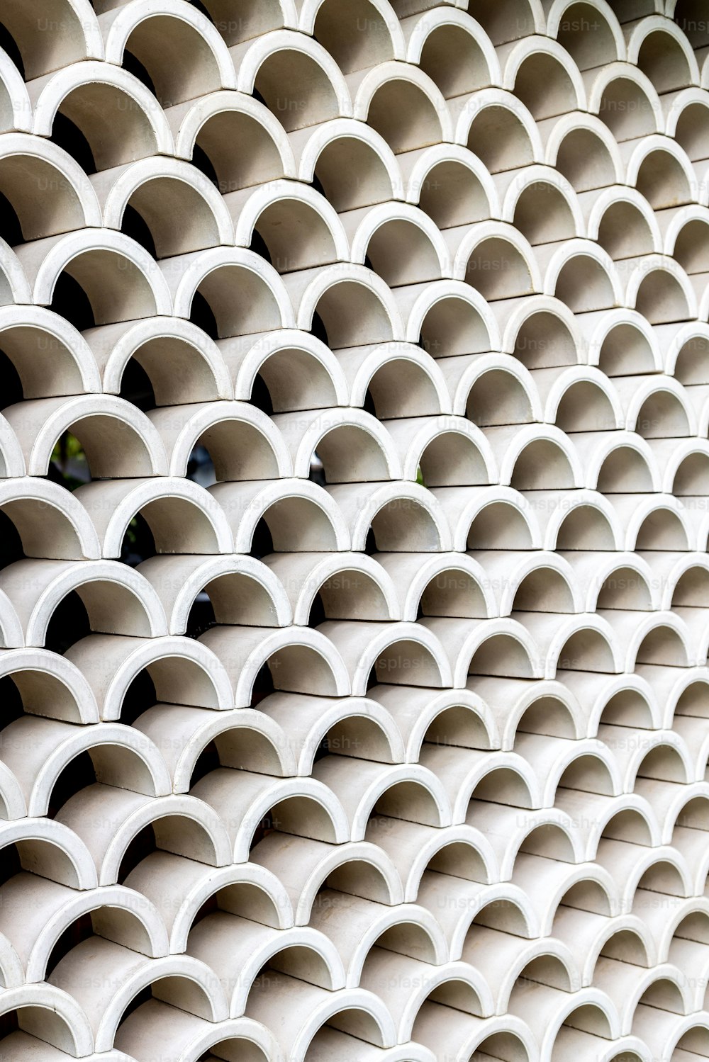 a close up of a wall made of white pipes
