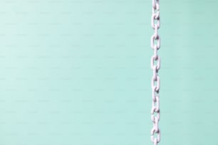 a close up of a chain on a green background