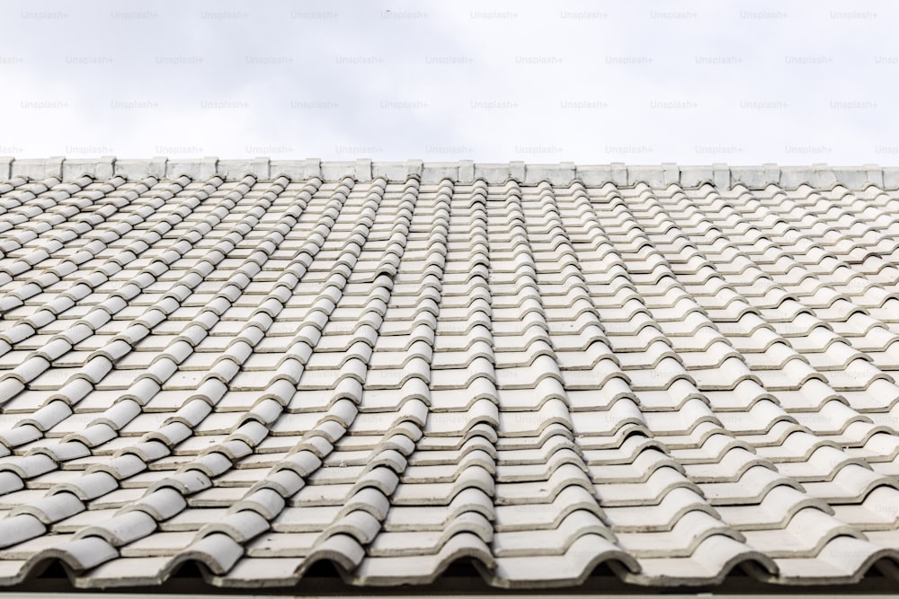 a close up of a tiled roof with a sky background